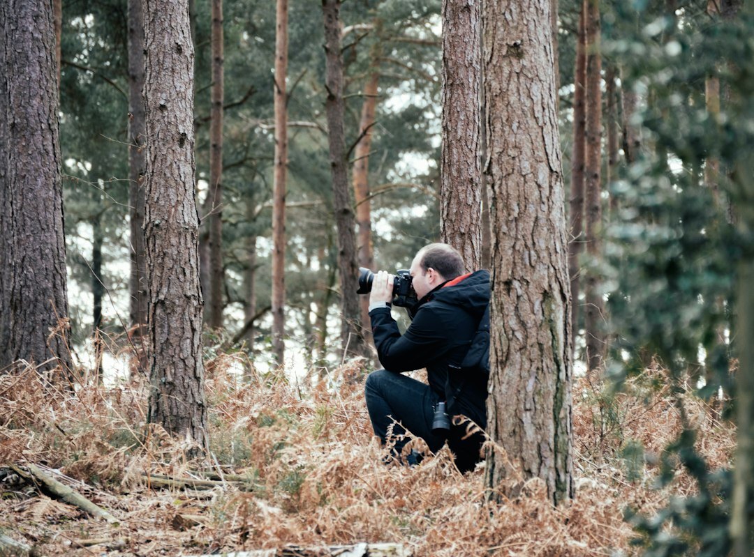 Documentary photographer kneeling to take a photo outdoors